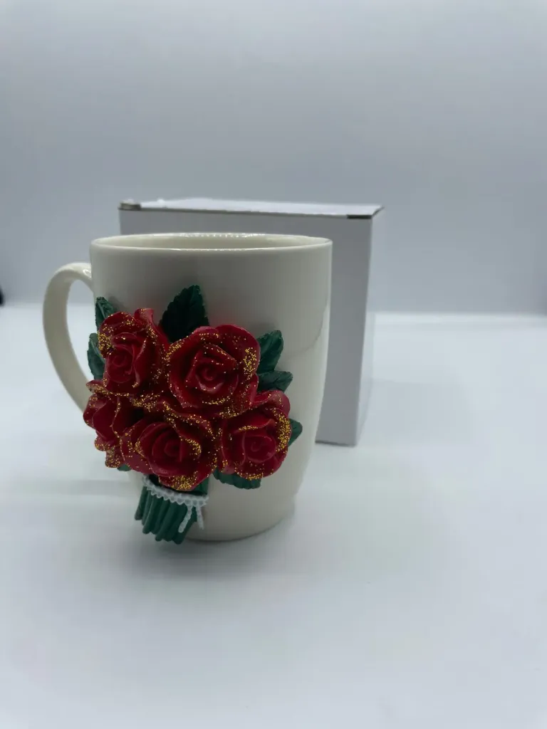 White ceramic mug with a handmade 3D polymer clay red rose bouquet design