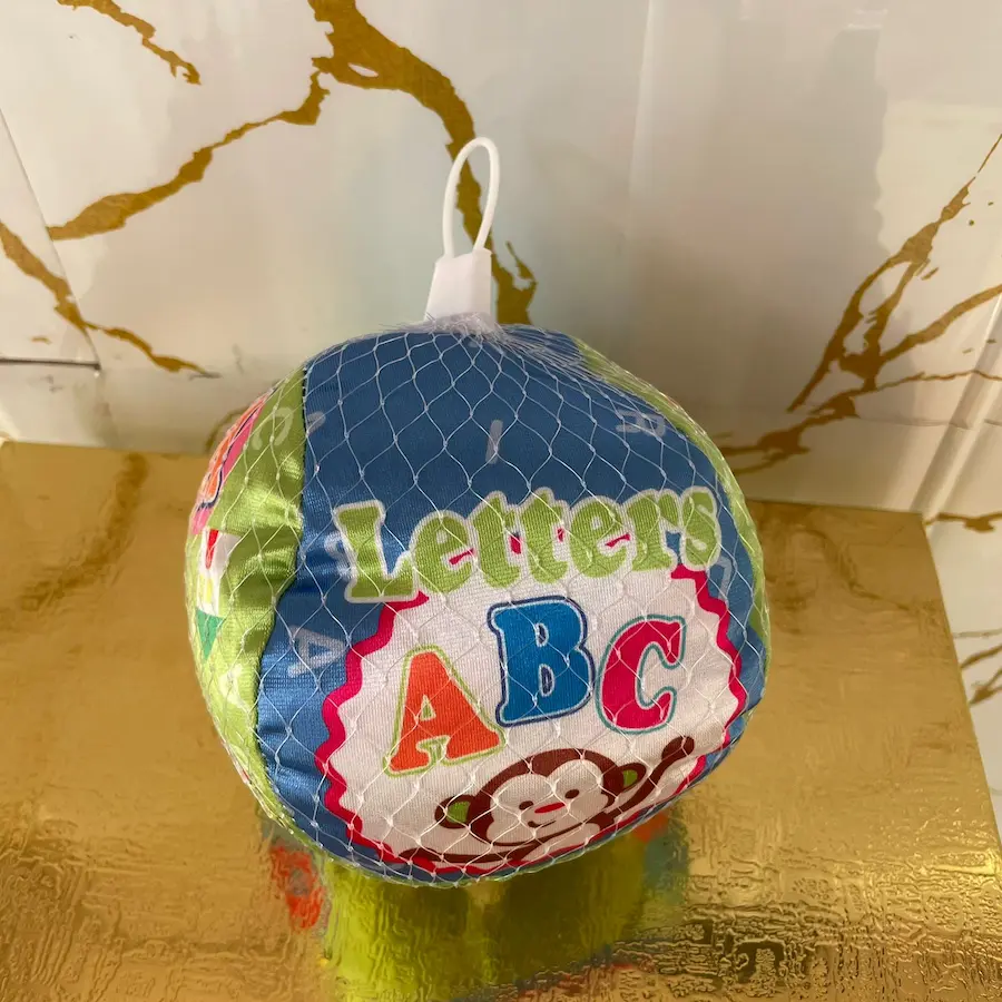 Soft sensory ball featuring letters and cartoon graphics.