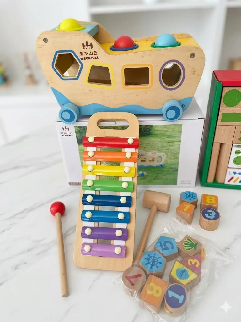 3-in-1 multifunctional educational toy set featuring a wooden ship shape sorter, a pounding bench with colorful balls, and a detachable 8-note xylophone.