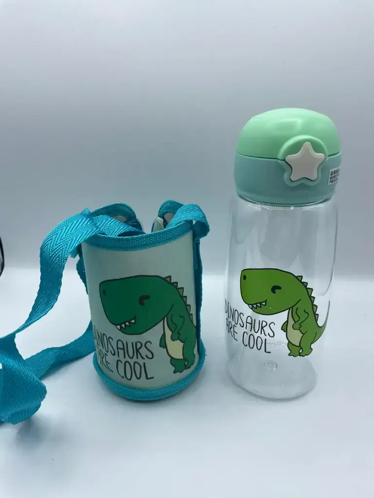 Cute children's 700ml water bottle featuring a playful cartoon dinosaur graphic and a matching purple shoulder strap pouch.