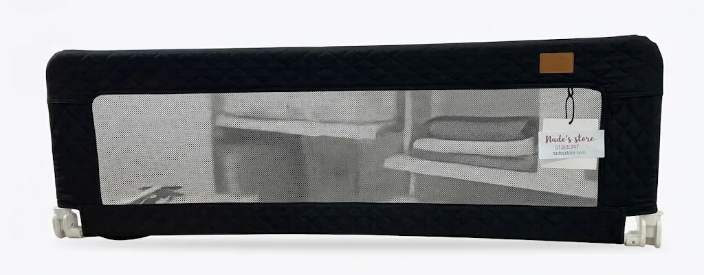 Baby bed rail guard with a mesh center and quilted Black fabric trim designed to prevent children from falling out of bed.