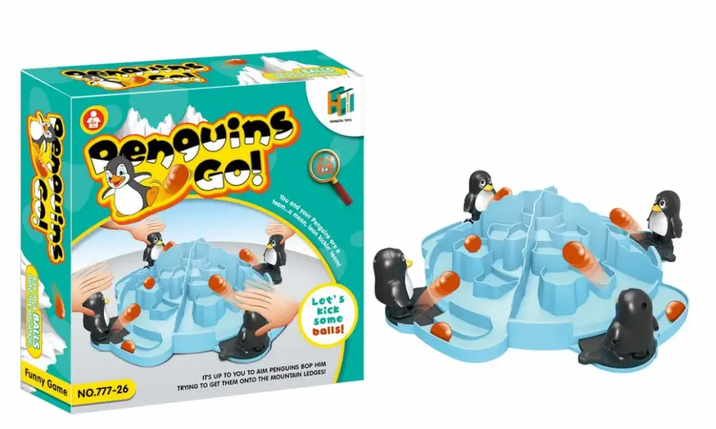 Penguins Go!, an interactive tabletop dexterity game where players use catapulting penguins to flick little orange "snowballs" onto a central iceberg platform