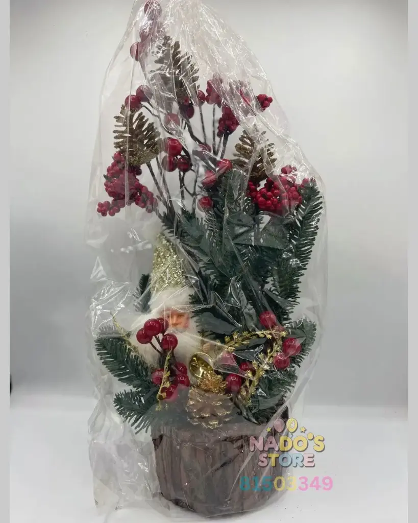 Artificial Christmas tree, decorated with faux snow and red berries. It is a tabletop decoration.