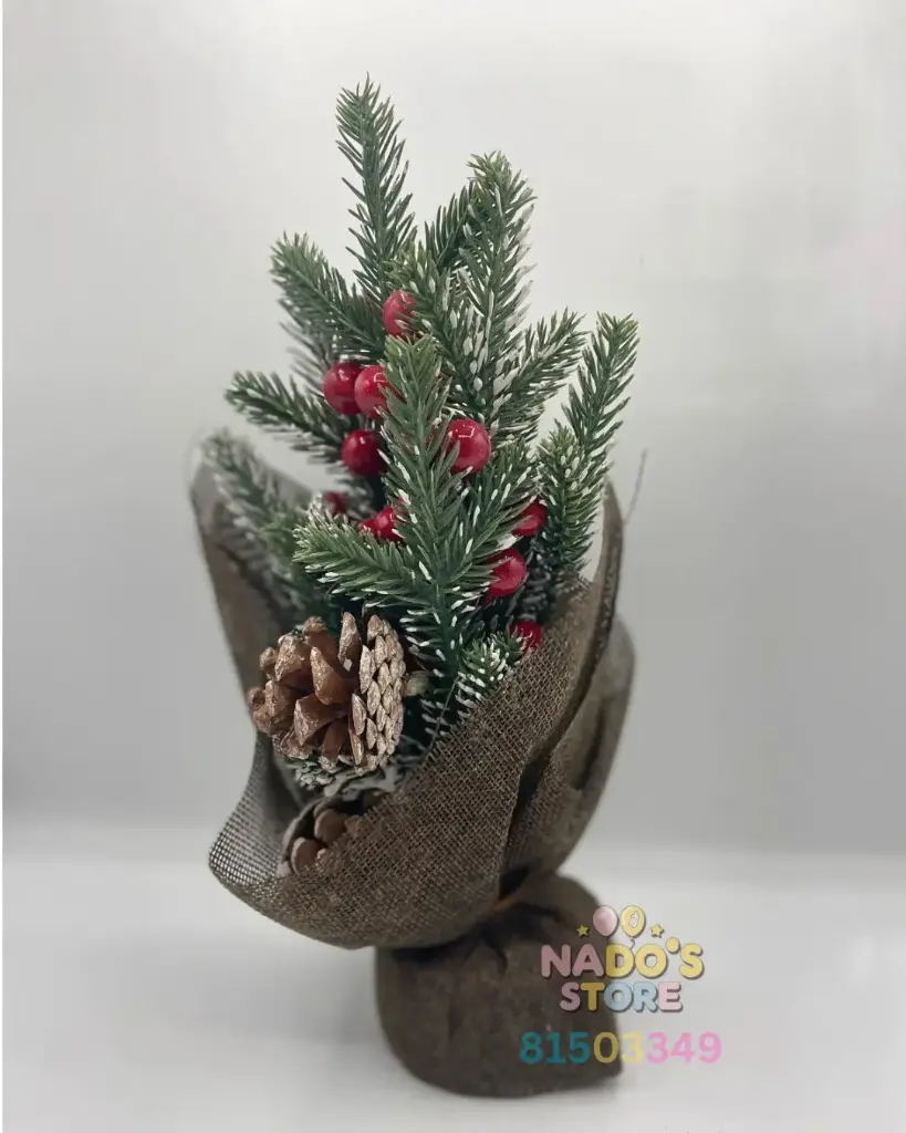 artificial Christmas tree, decorated with  red berries. It is a tabletop decoration.